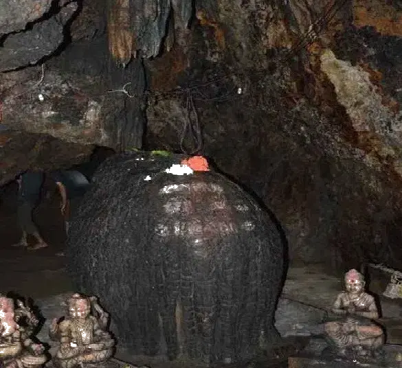 Ancient stalactite formations inside Kavala Caves near Dandeli with Shiroli Peak viewpoint above