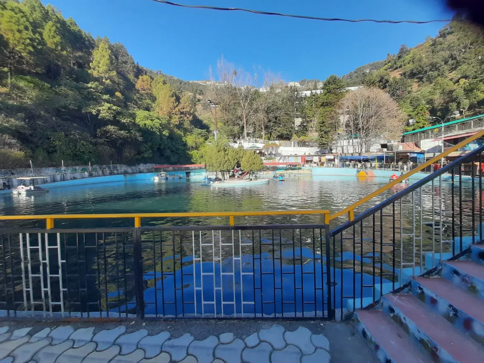 Mussoorie Lake surrounded by green hills on the Dehradun road
