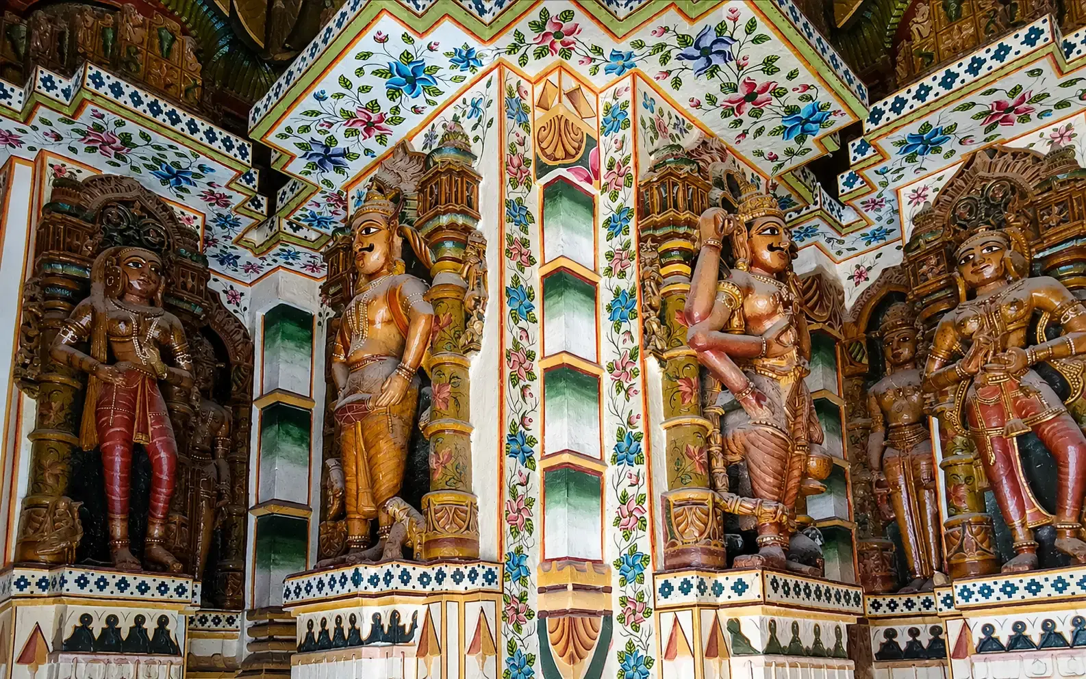 Vibrant golden interior with intricate carvings and mirror work inside the 16th-century Bhandasar Jain Temple in Bikaner