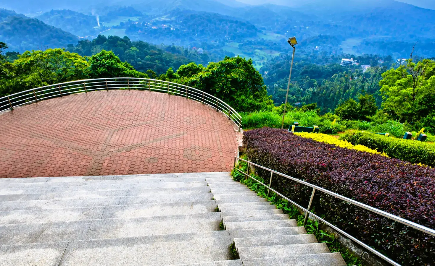 Terraced garden viewpoint overlooking green hills at Raja's Seat in Madikeri