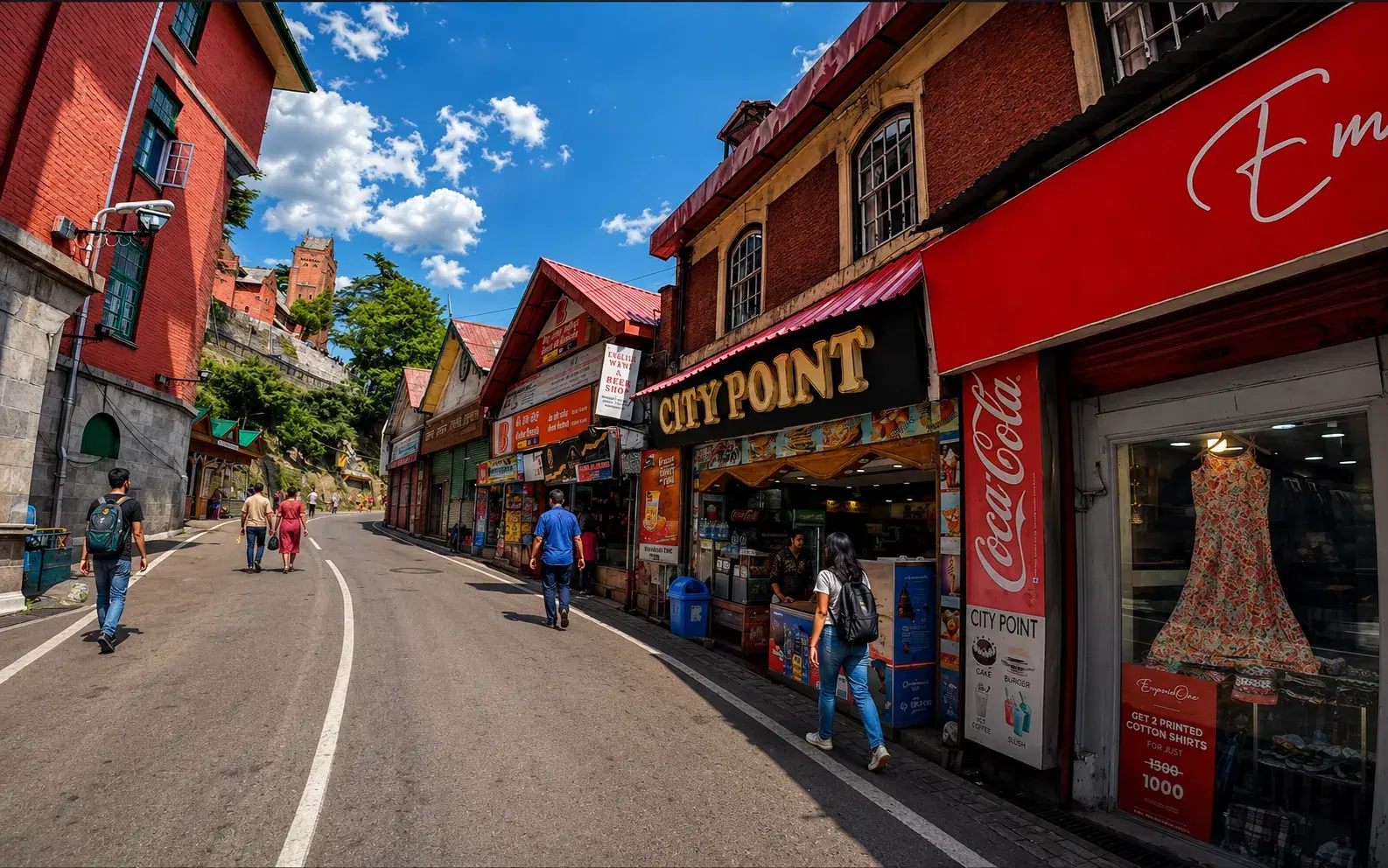 Pedestrians walking past shops and red-brick buildings on Mall Road in Shimla
