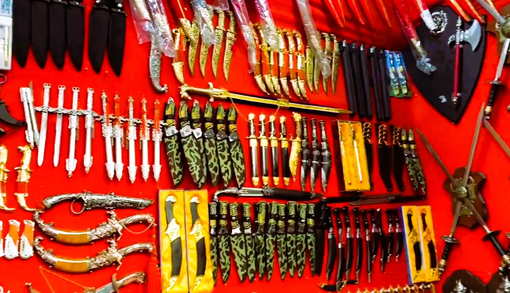 Decorative knives and souvenir blades displayed at a Pushkar Bazaar stall