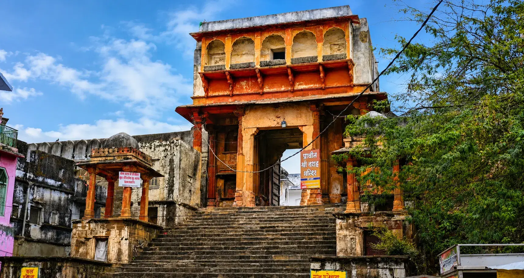 Orange entrance gateway and stone steps of Shri Varaha Temple in Pushkar