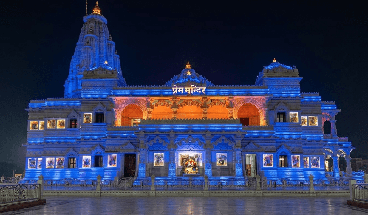 Prem Mandir illuminated at night with 94-ft white marble structure and Radha-Krishna tableaux in Vrindavan