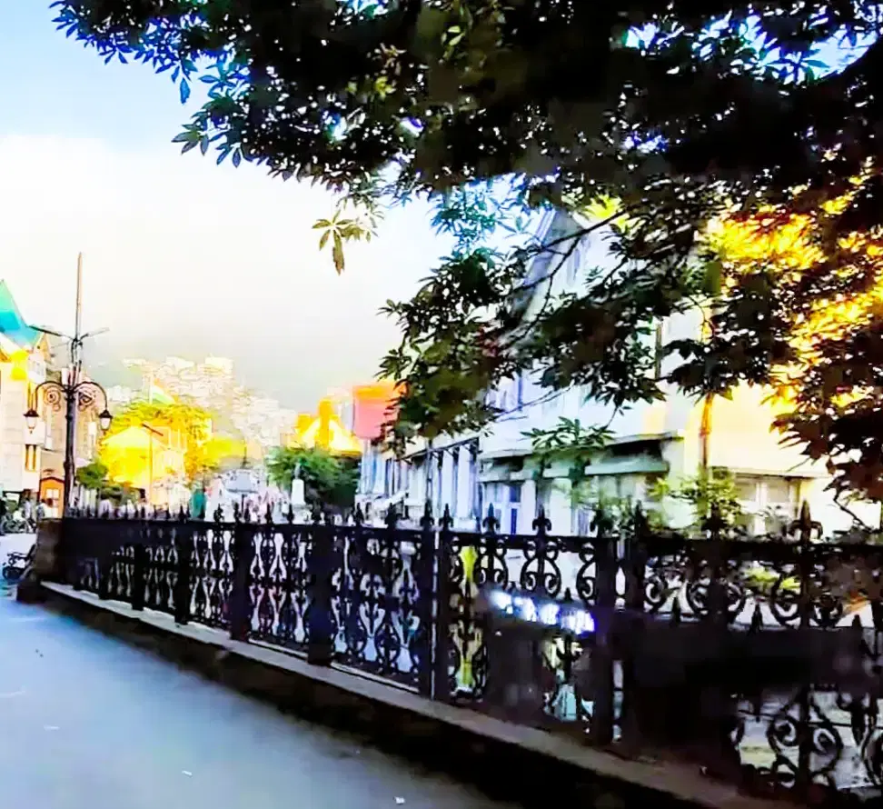 Lakeside promenade of Mall Road in Nainital with mountains reflected in the lake
