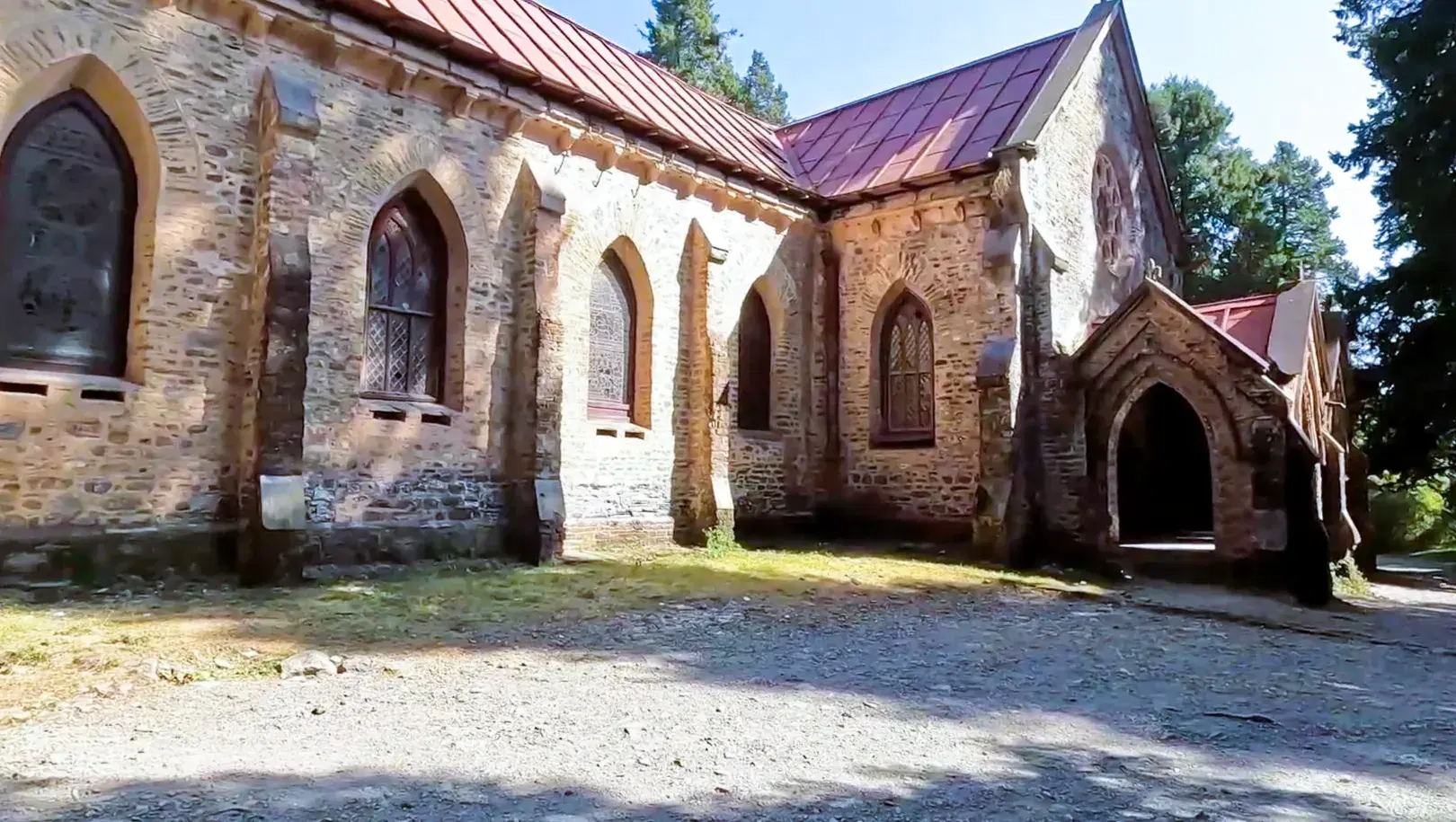 Back view of St. John in the Wilderness Church surrounded by pine trees in Nainital