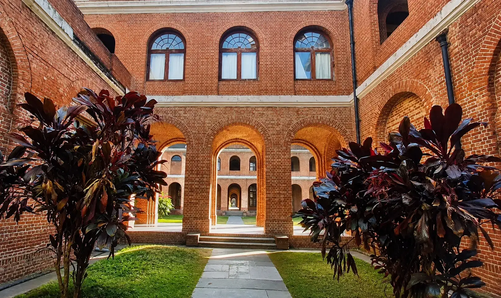 Red-brick arched courtyard inside the Forest Research Institute in Dehradun