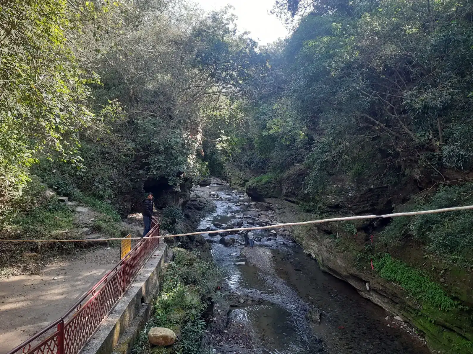 Rocky river channel and forest beside Tapkeshwar Mahadev Temple in Dehradun